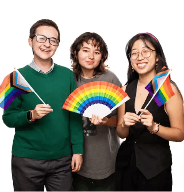 3 students holding rainbow colored flags and fans
