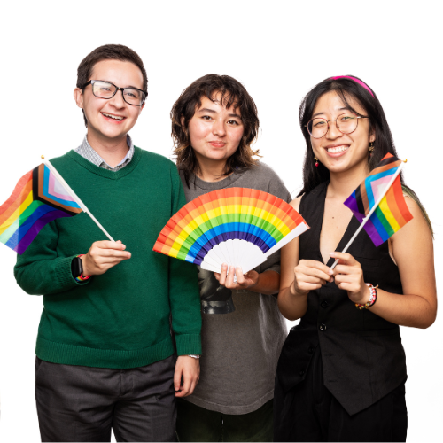 Three students holding rainbow flags and a fan.